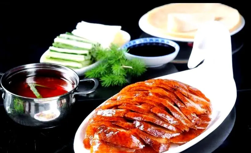 Peking duck sliced and served with pancakes, scallions and sauce