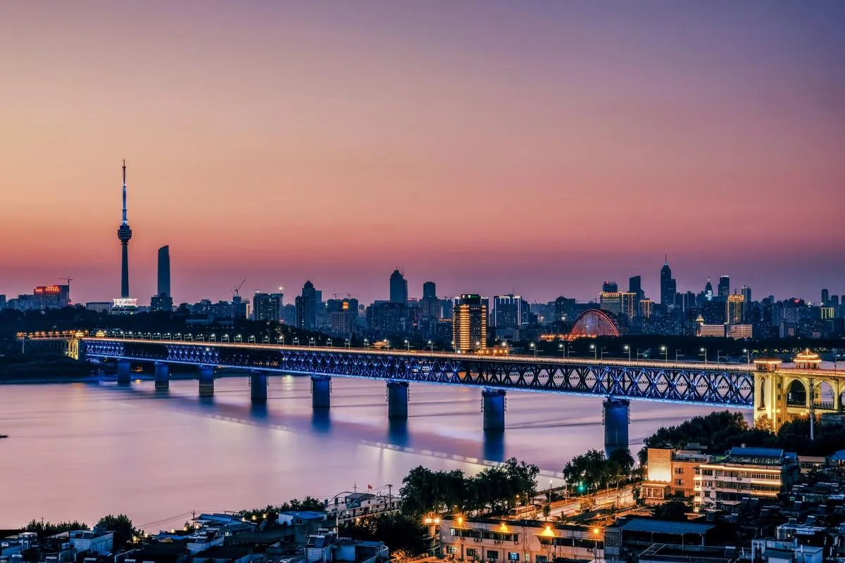 The Wuhan Yangtze River Bridge at dusk, with the city skyline and TV tower