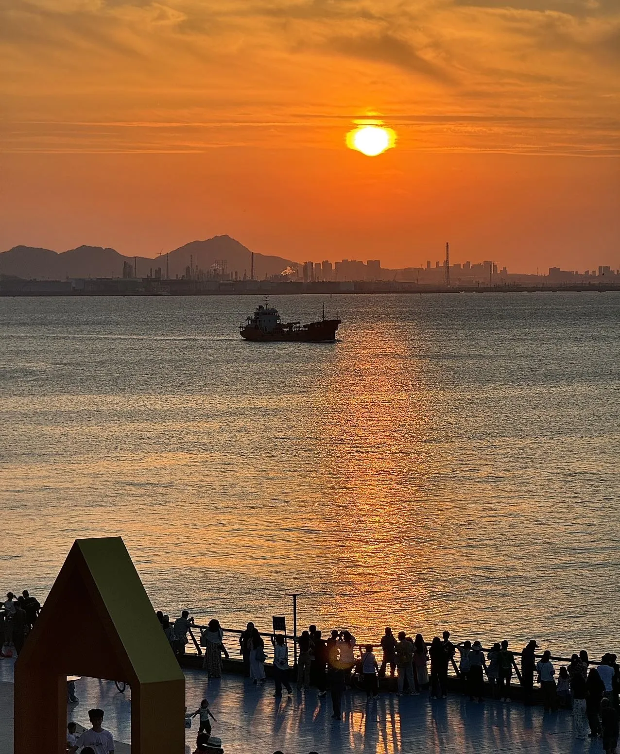 Qingdao seaside at dusk, with Zhanqiao Pier reaching into the bay