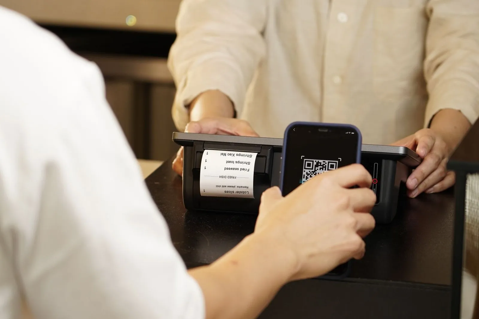 Paying by phone at a convenience store counter