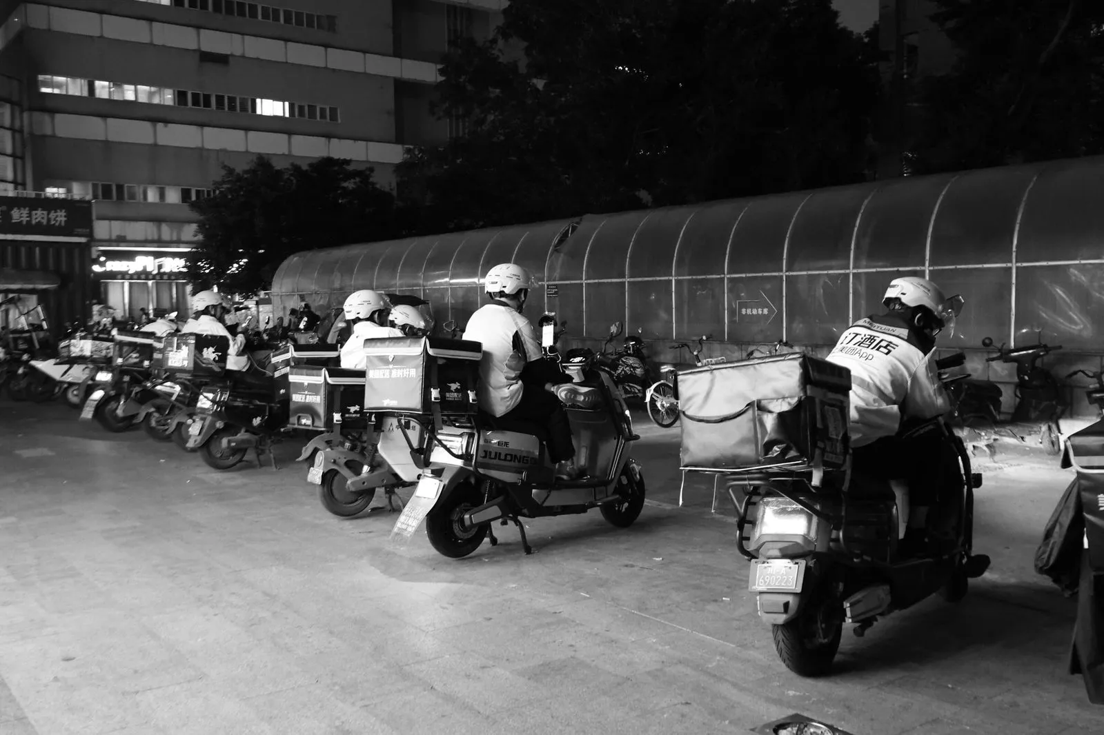 A food delivery rider on an electric scooter in a Chinese city