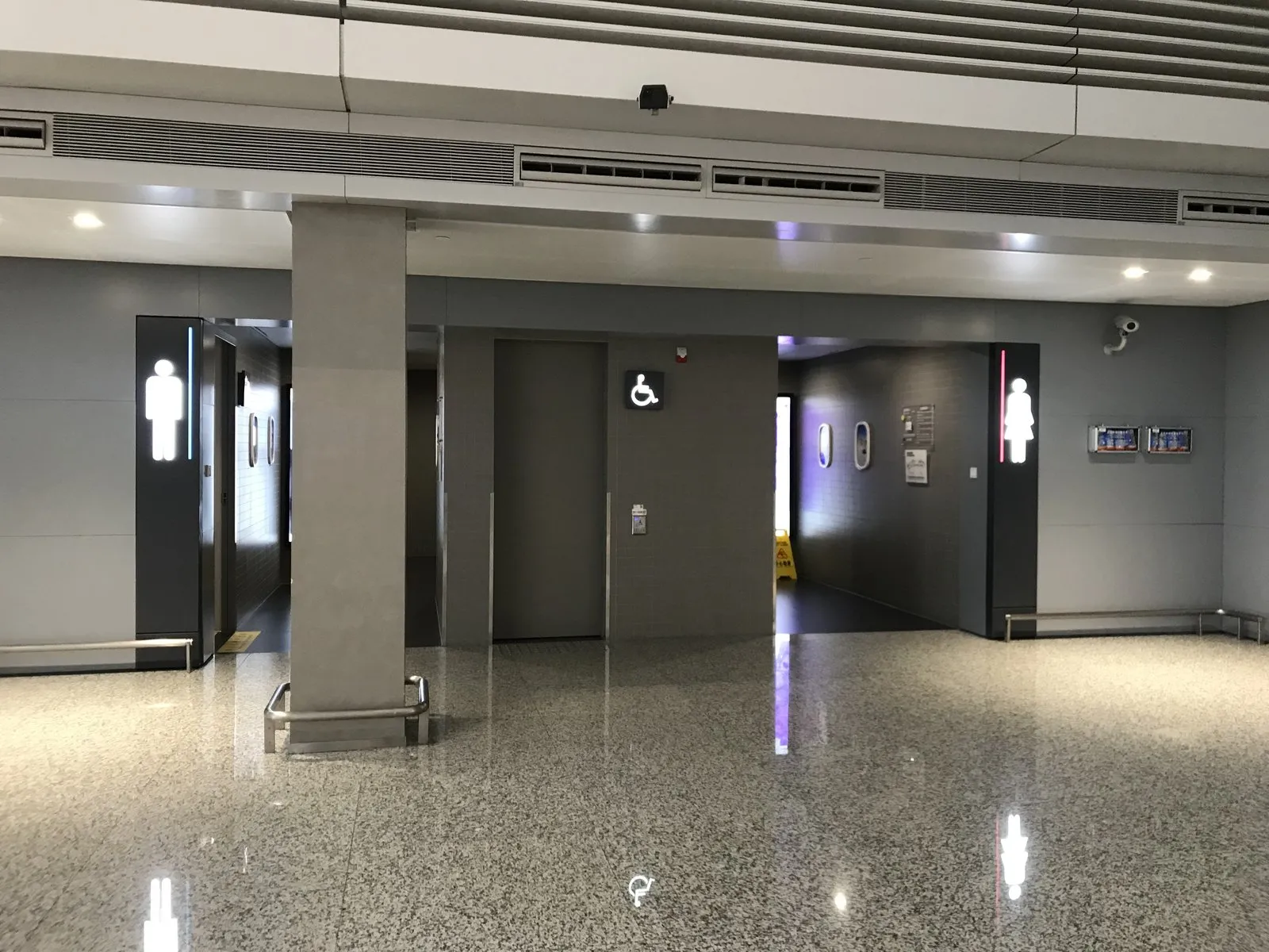 Restroom entrances at Shanghai Hongqiao International Airport Terminal 1, with backlit men's and women's signs and a separate accessible toilet