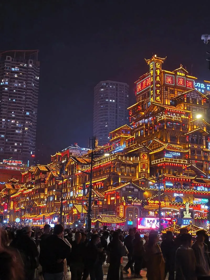 Hongya Cave in Chongqing -- stilted buildings clinging to a cliffside, glowing at night