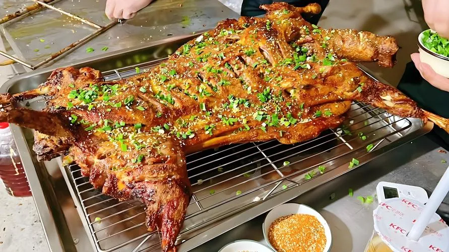 Roast Whole Lamb — an entire lamb rotating slowly over charcoal, skin golden and crackling