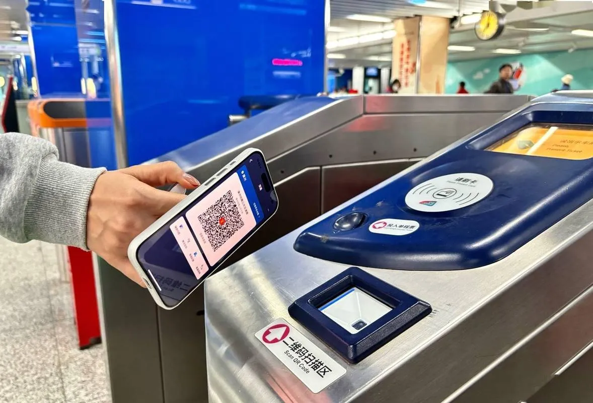 Scanning a transit QR code at the subway gate