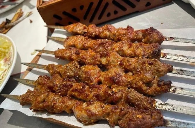 Xinjiang Lamb Skewers — lamb cubes sizzling over charcoal, dusted with cumin and chili powder